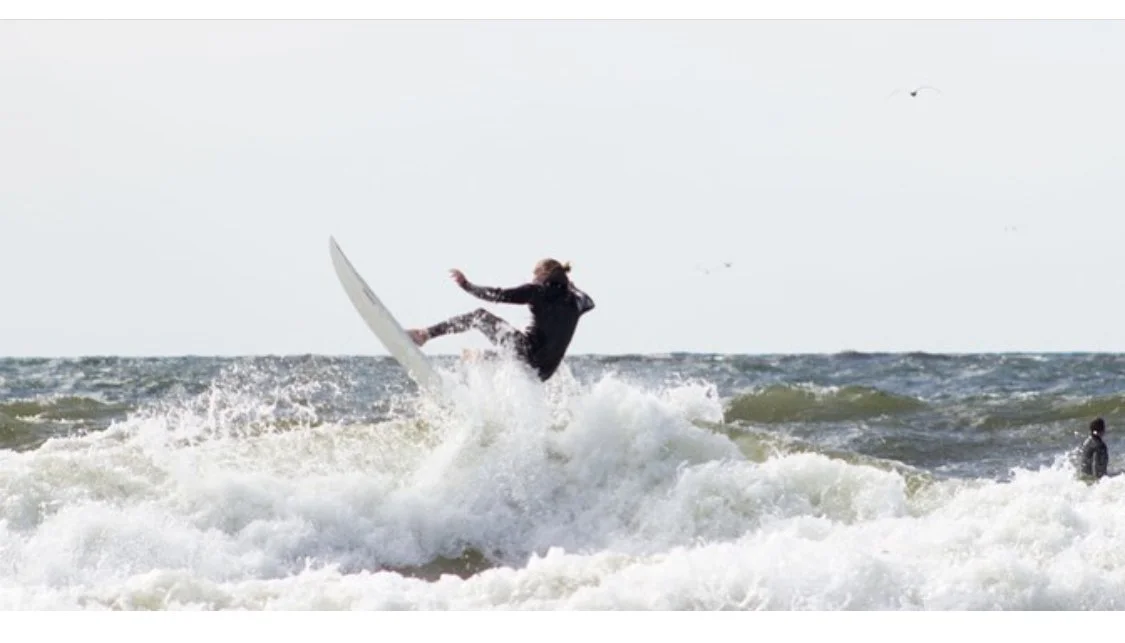 Nick VanderSys surfing in Grand Haven
